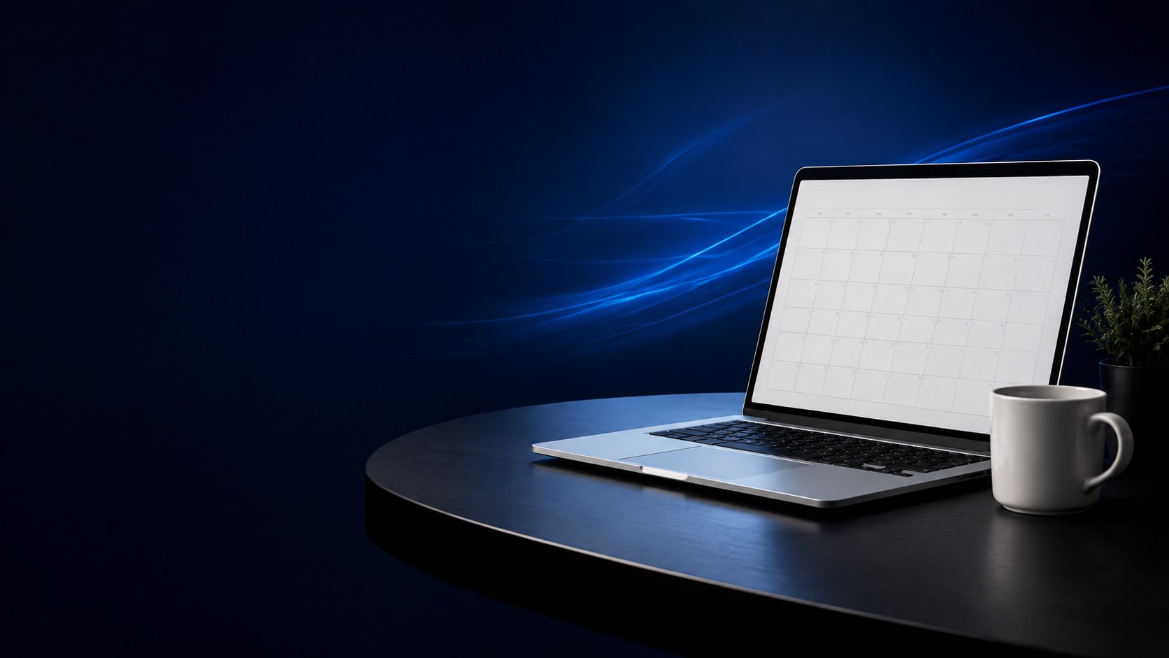 Laptop dengan kalender, tanaman, dan cangkir di meja kerja